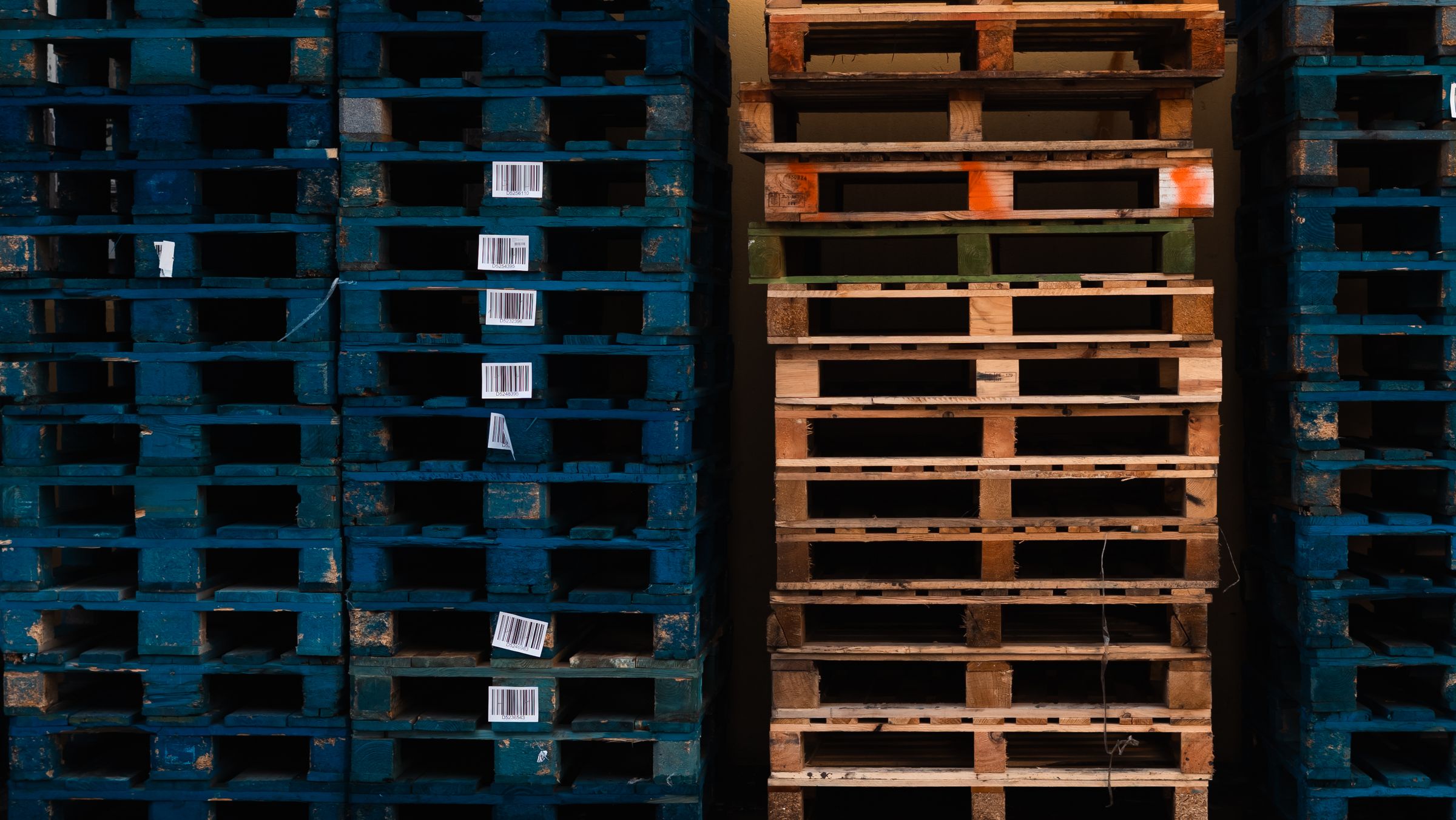 Stacks of wooden pallets inside a warehouse